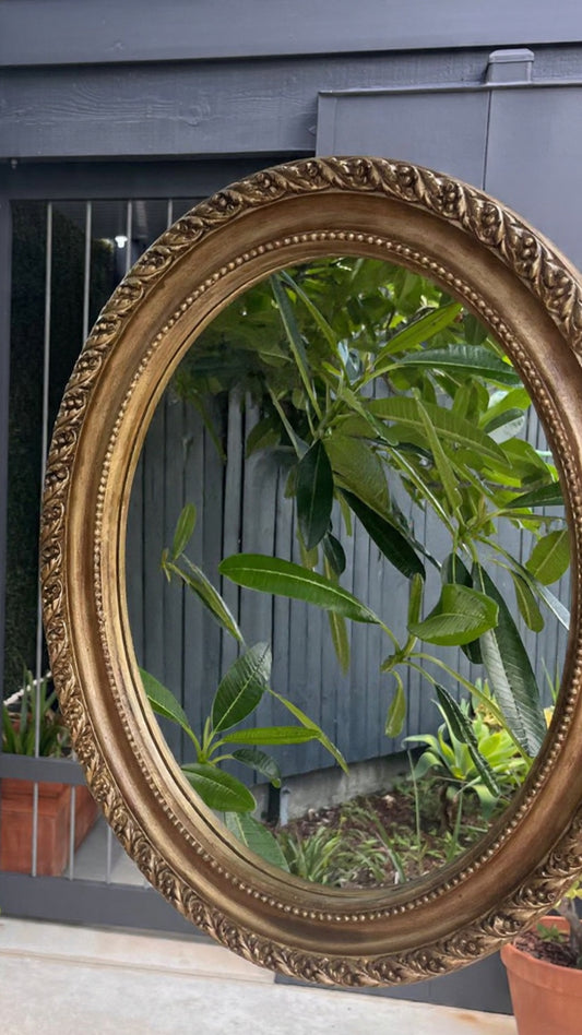 Vintage ornate gilt framed oval mirror